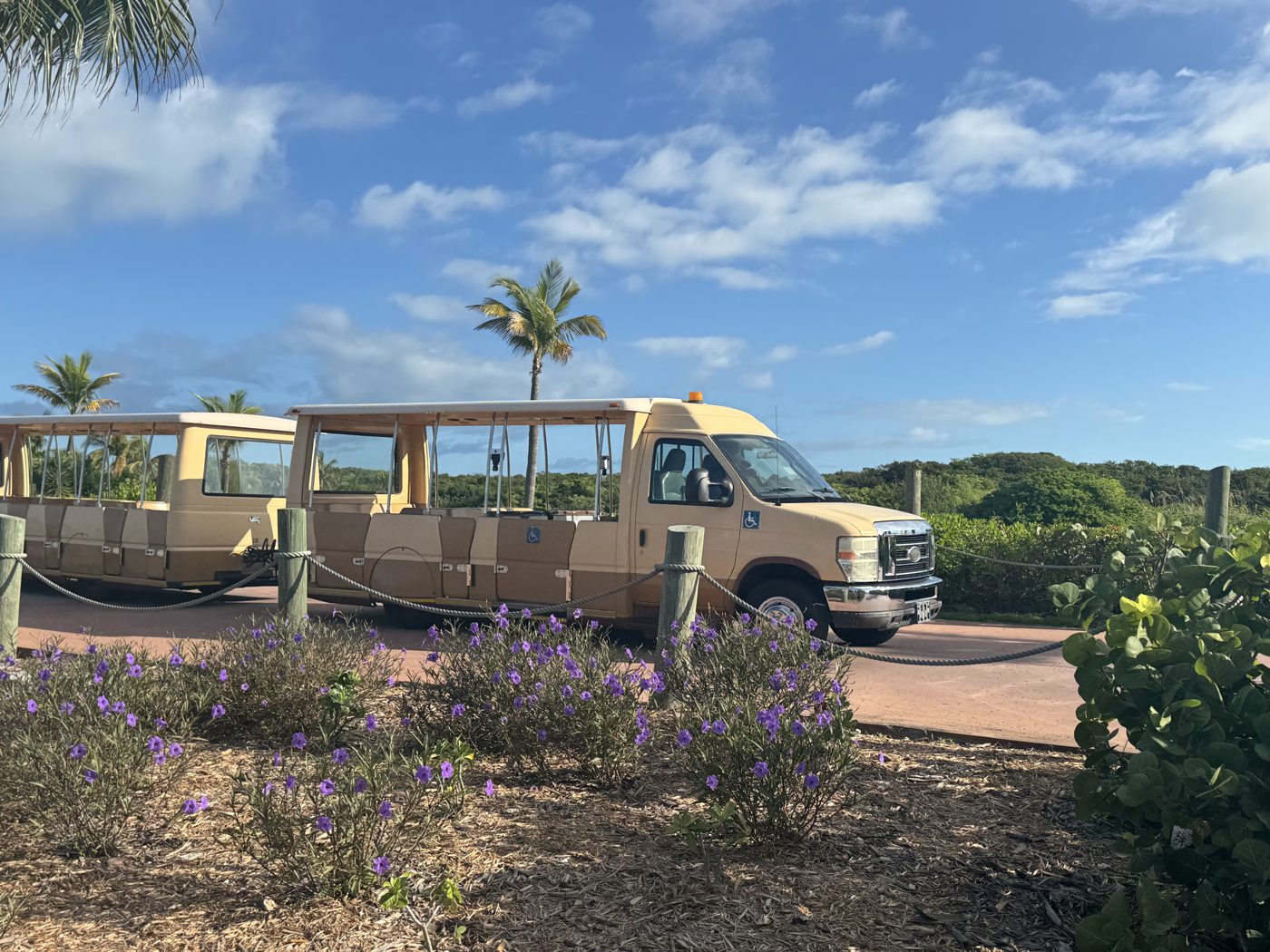 Wheelchair-accessible tram at Castaway Cay, marked with the accessibility symbol, used to move guests between areas of the island