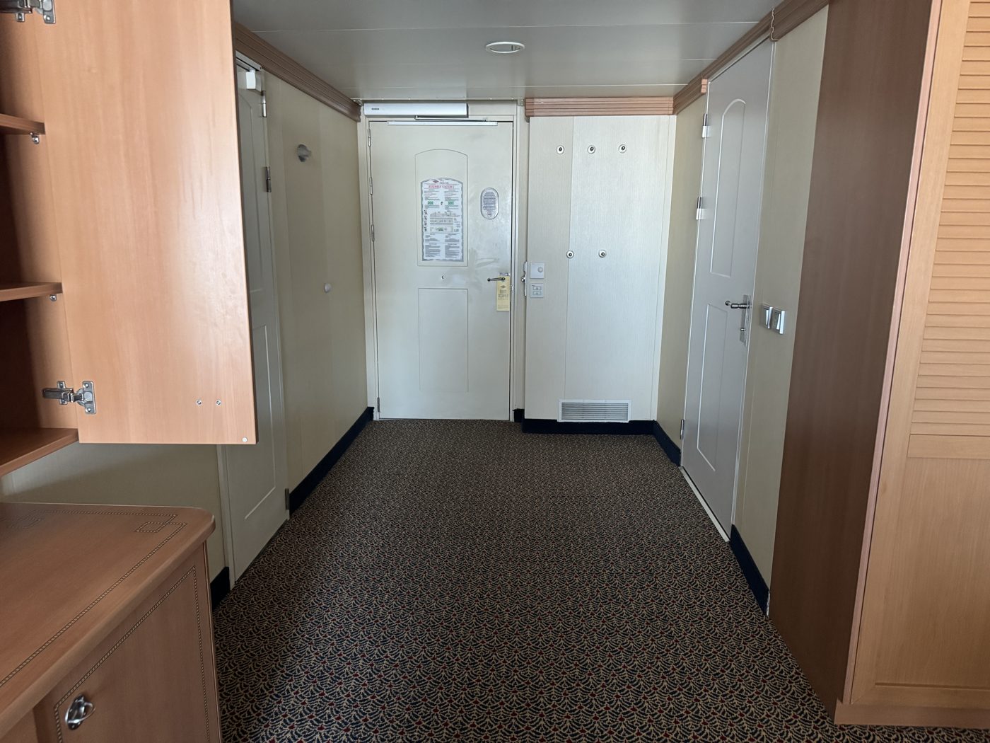 Zero-threshold entryway into a Disney Cruise Line accessible stateroom bathroom, with no raised lip between the cabin and bathroom floor