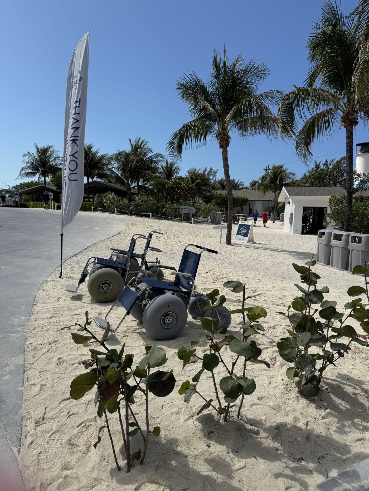 Beach wheelchairs with large balloon tires parked in the sand at Great Stirrup Cay
